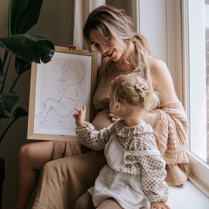 Mother looks to the calendar with her daughter