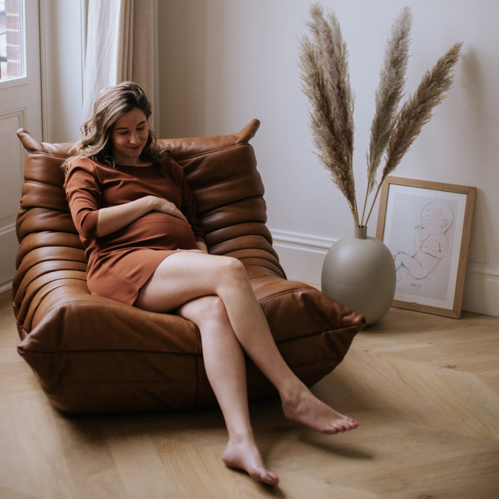 Pregnant woman in front of the Nine Months Calendar